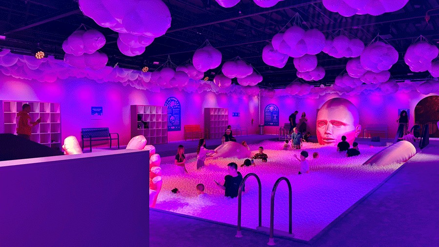 Families exploring the world’s largest bubble bath ball pit at Bubble Planet, a family-friendly experience
