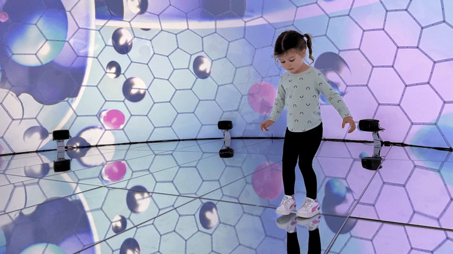 young girl in Giant Bubble Room with stunning visuals and mirrored floors
