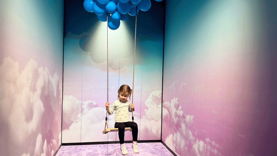 young girl swinging at Bubble Planet, a new immersive experience in Bellevue