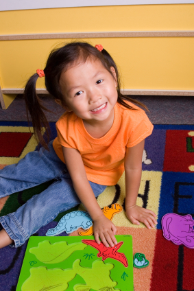 Girl with dinosaur puzzle