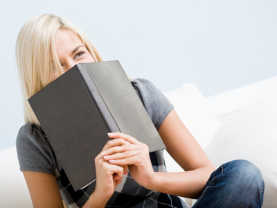 Laughing mom reading book