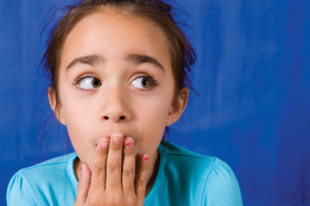 girl with hand over mouth