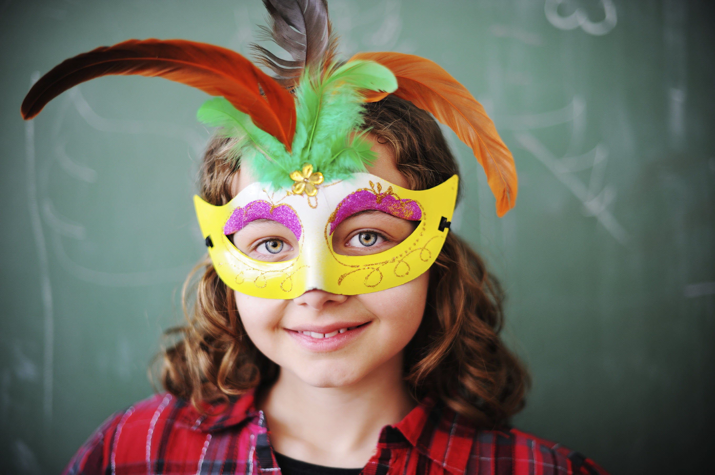 Student in school drama program with mask