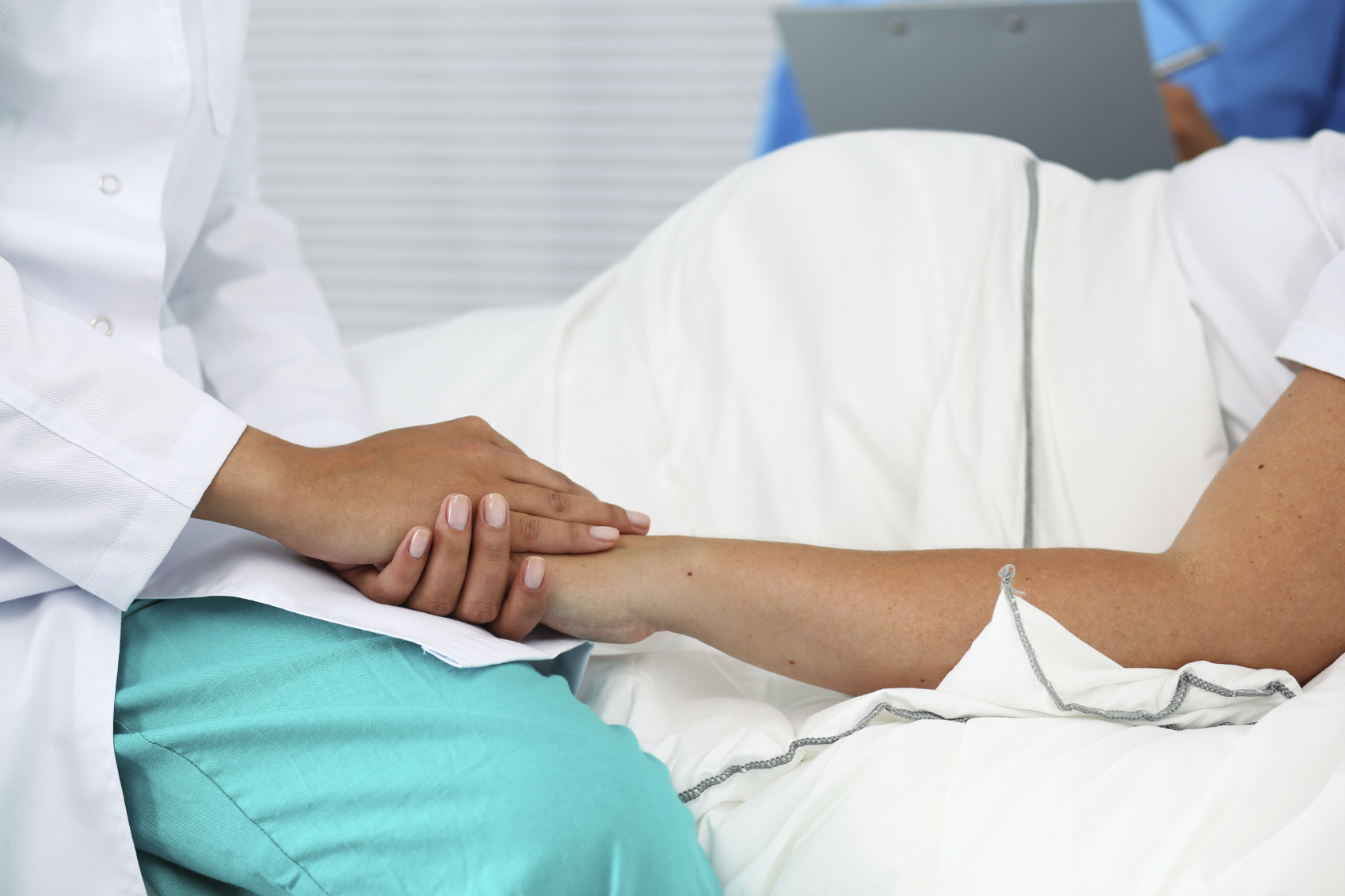 OBGYN holding pregnant patient's hand