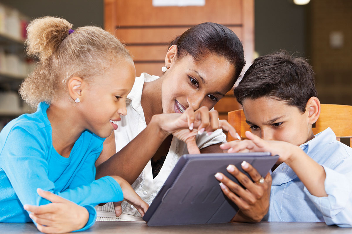 librarian helping kids on screen