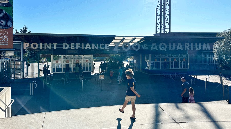 "Young boy walking into the entrance of the Point Defiance Zoo & Aquarium"