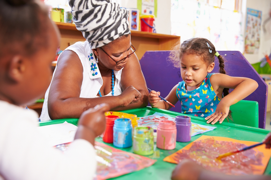 "Co-op preschool parent helping at at art table"