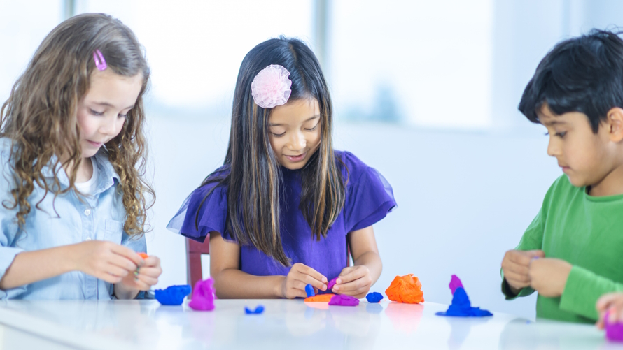 "Kids playing with play dough at an eco-friendly birthday party"