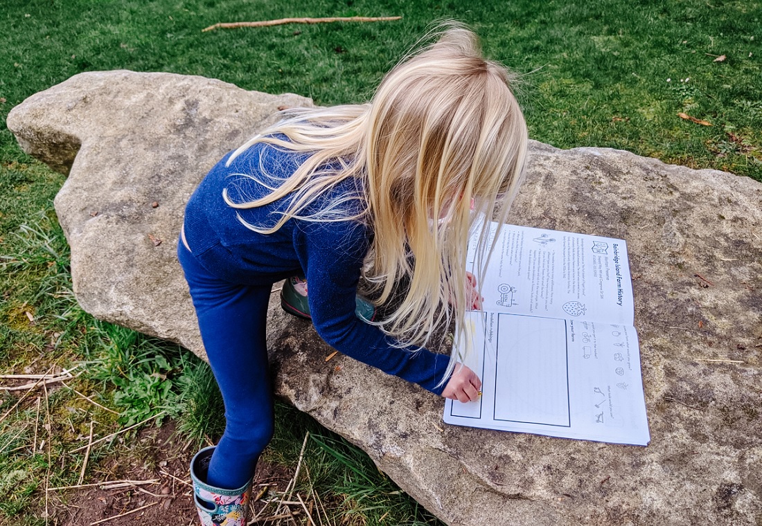 Girl sitting on a rock at Moritani Preserve on Bainbridge Island