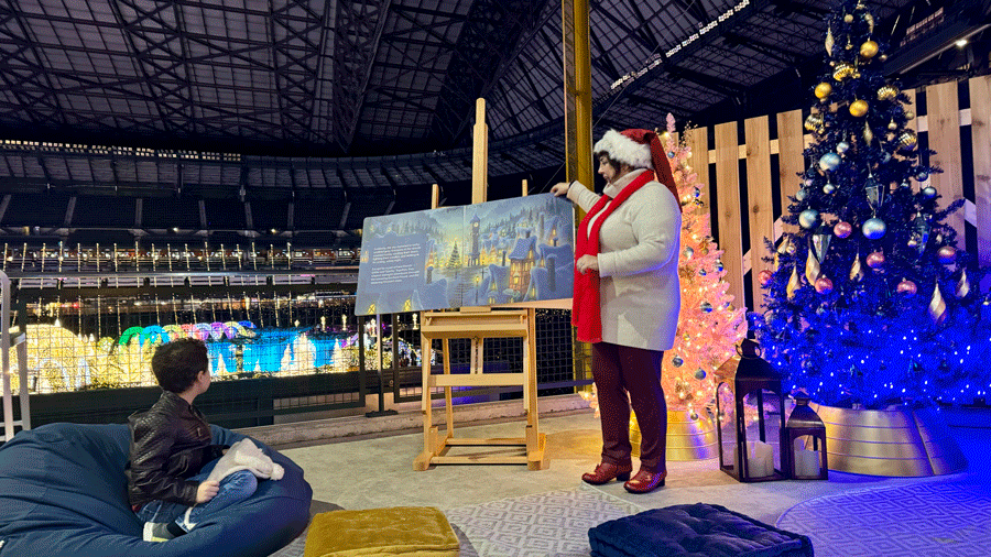 Mrs. Claus reading a story in her reading room at Enchant Christmas, a Seattle holiday attraction