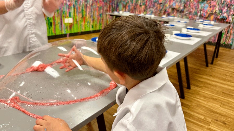 playing with slime during an indoor birthday party at the Slime Factory