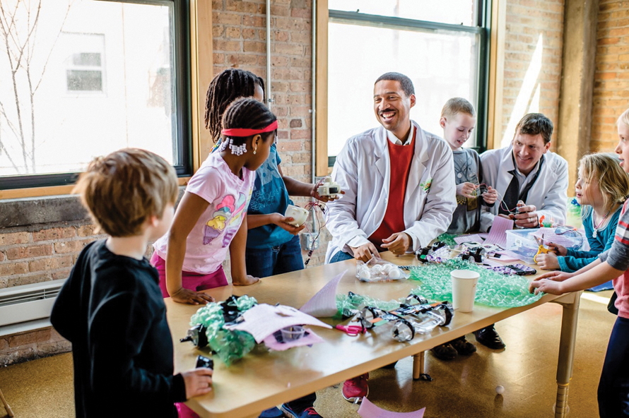 kid science labs kids gathered around a table full of craft materials