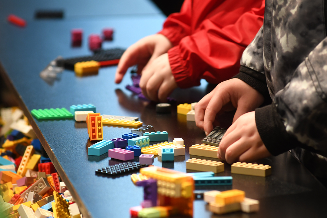 kids play with lego at building stations at Awesome Exhibition The Interactive Exhibition of Lego Models at Seattle Center Fisher Pavilion