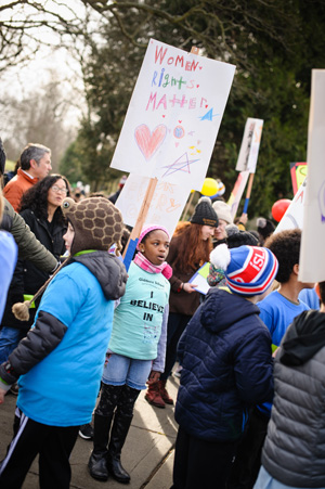 giddens student holding a sign at a public demonstration