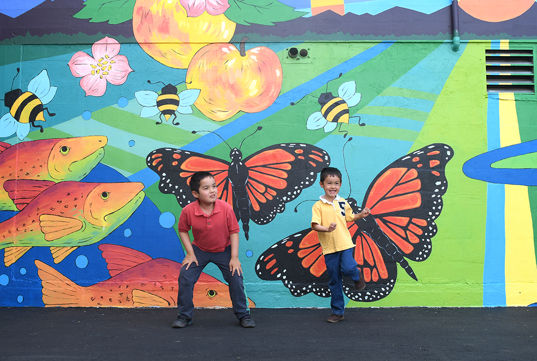 Colorful mural with boys in the foreground a Skagit Valley coop in Mount Vernon, Wash.