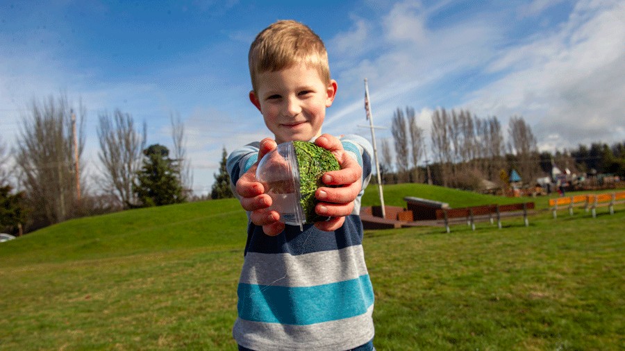 young kid with a clue ball during Northwest Glass Quest, participating in the Kind Quester program