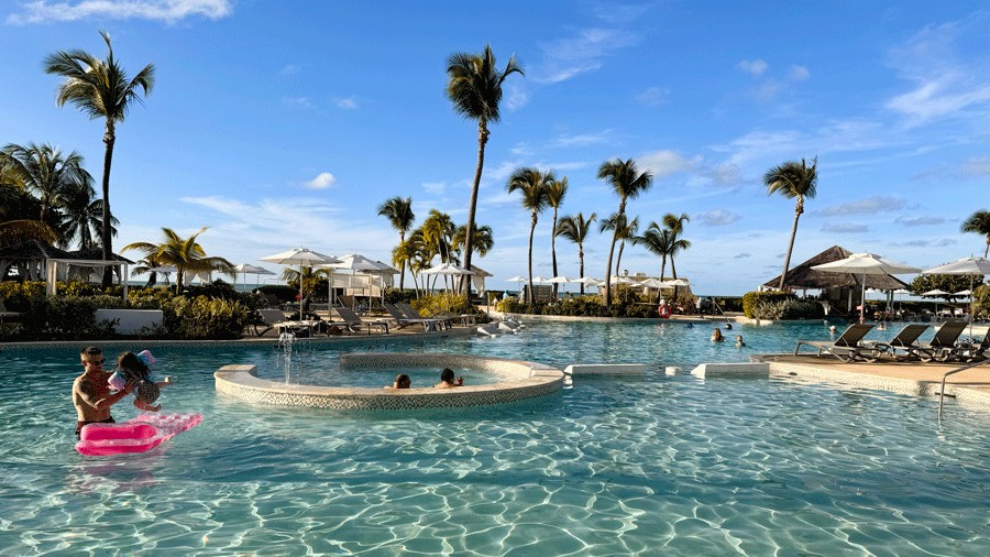 Lagoon Pool at Hyatt Regency Grand Reserve Puerto Rico with families swimming in the water