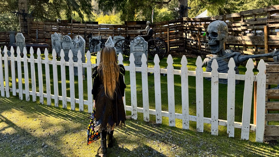 Young girl looking at haunted graveyard on a haunted woods walk near Seattle