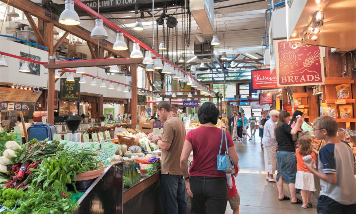 View of shopping stalls at Granville Island public market in Vancouver, BC, Canada fun family weekend one tank of gas from Seattle