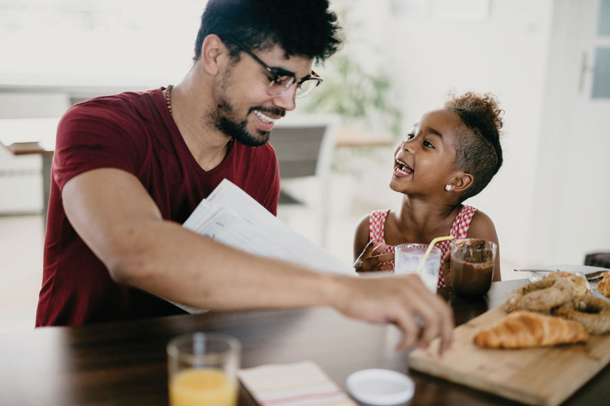 father and daughter trying new food