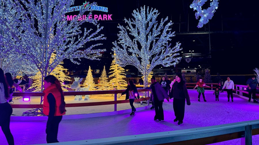 families ice skating at Enchant Christmas, a Seattle ice skating rink and holiday attraction