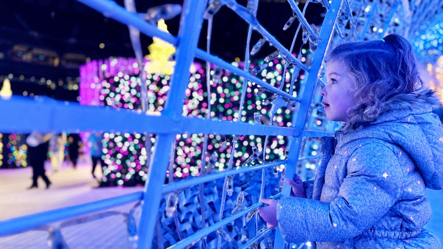 young girl watching other maze participants at Enchant Christmas in Seattle