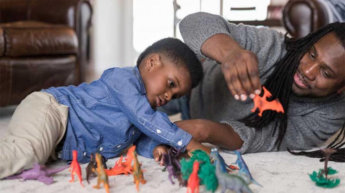 Father-and-son-playing-with-dinosaur-crafts