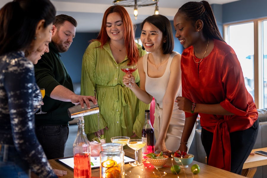 people at a party learning how to make mixed drinks