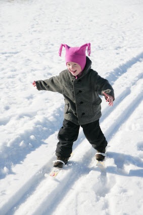 small girl cross country skiing