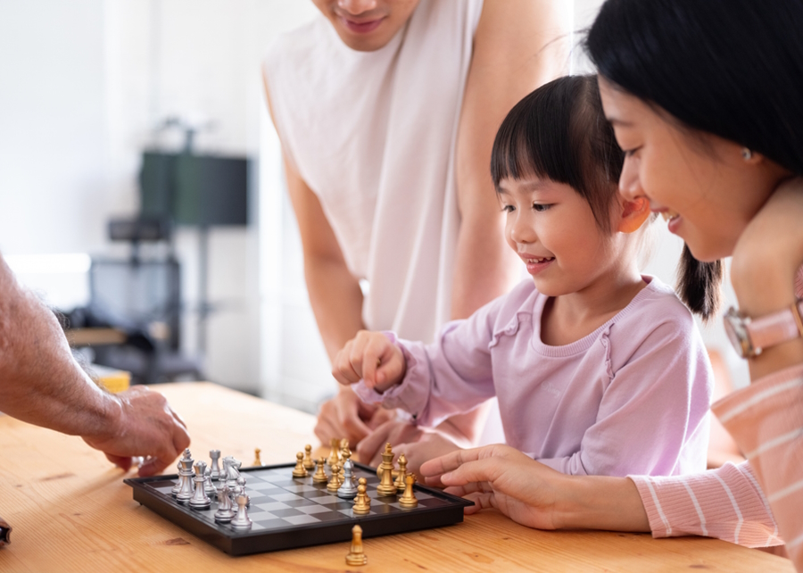 Girl learning how to play chess