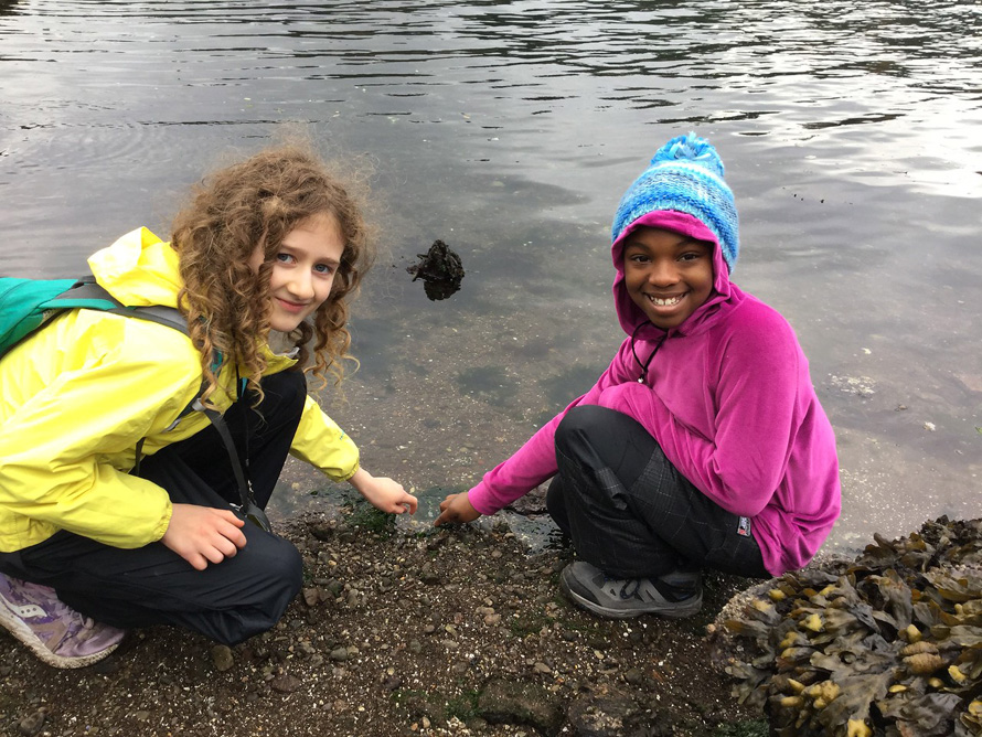 two students tidepooling