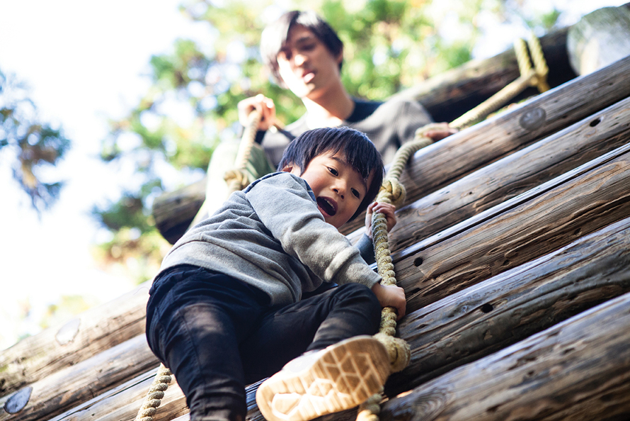 kid climbing a wall at camp