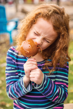 girl eating caramel apple