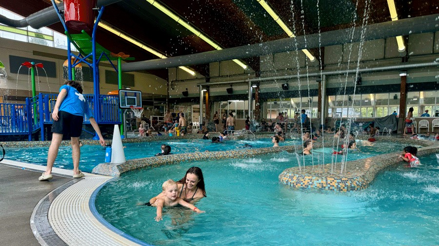 family swimming in the lazy river at Lynnwood Recreation Center indoor pool, an indoor Seattle activity for families