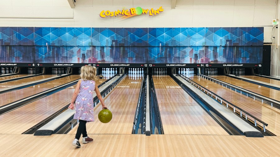 young girl bowling at Spin Alley Bowing, a Seattle indoor activity for families