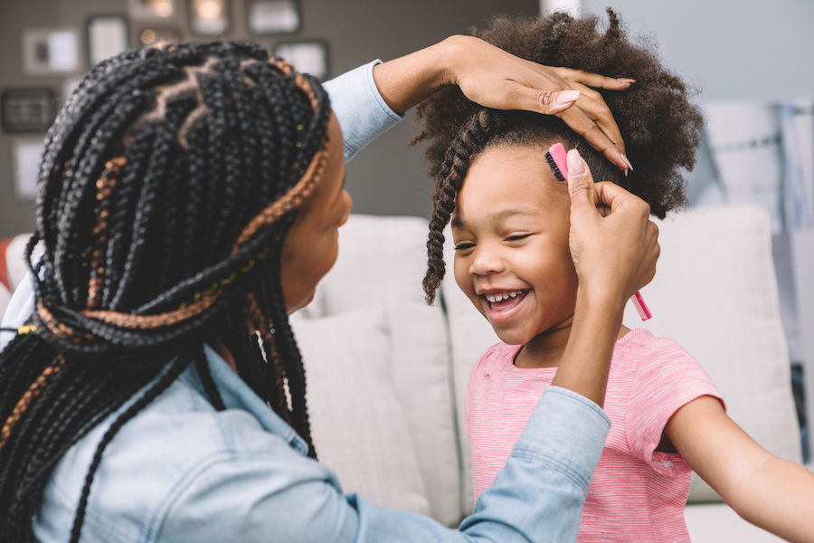 mom doing her daughter's hair