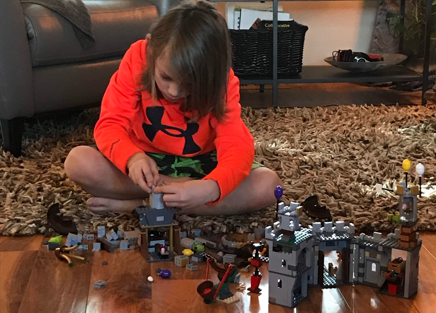 Young boy playing with Lego bricks