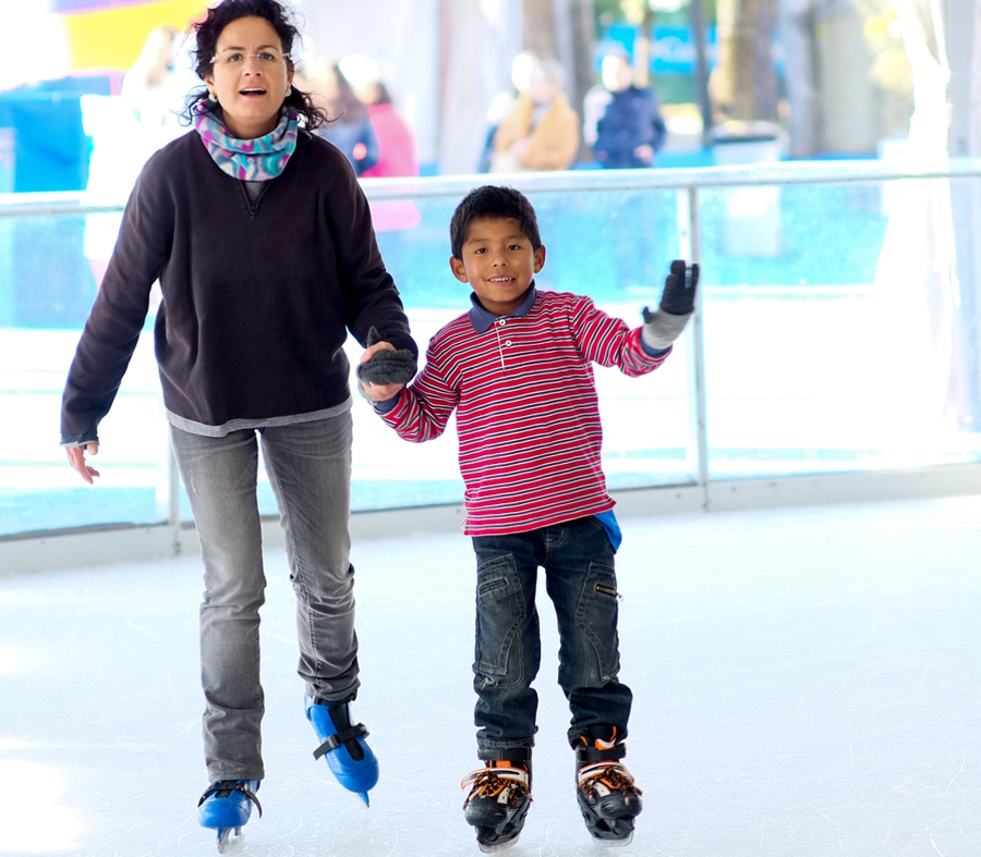 mom and son at an indoor ice-skating rink holiday family fun