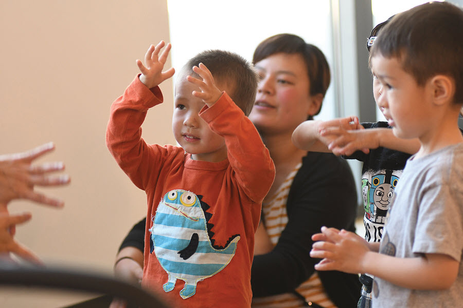 Young children participating in a library story time