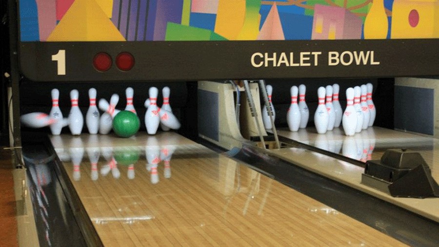 bowling ball hitting pins at Chalet Bowl, a fun retro activity in Tacoma