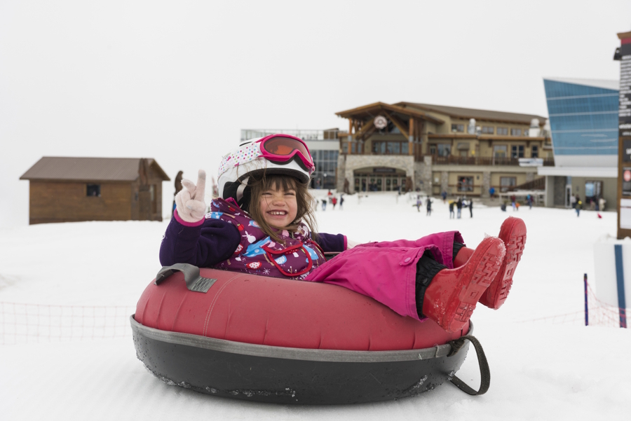 girl in a snow tube at Whistler