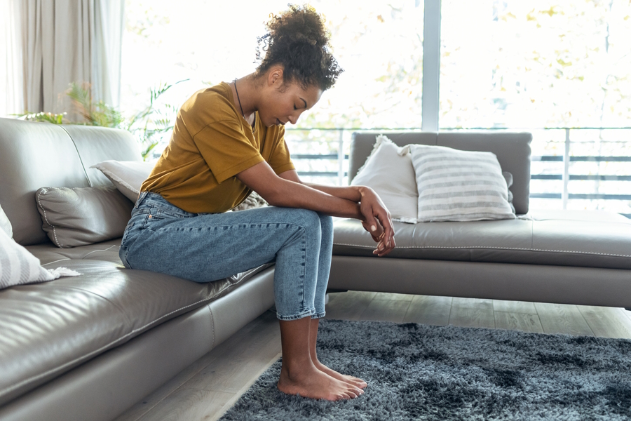 woman on a couch taking a breath 