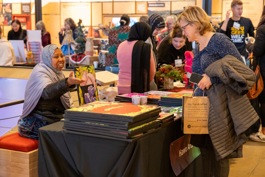 A woman purchasing a special holiday gift at the Giving Marketplace