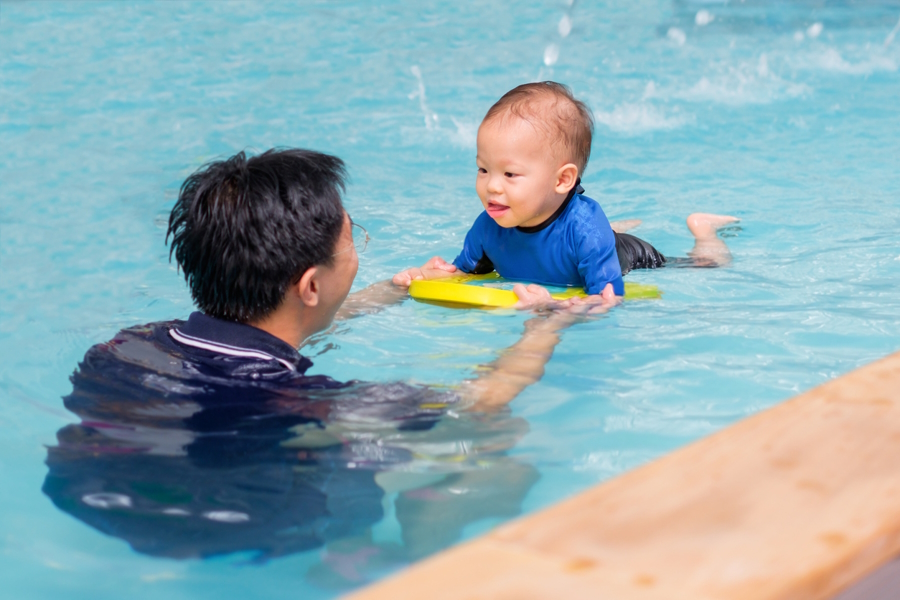 Little boy in a swimming lesson