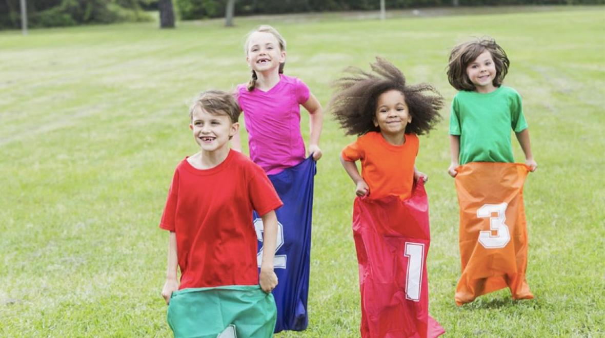 Kids doing a potato sack race