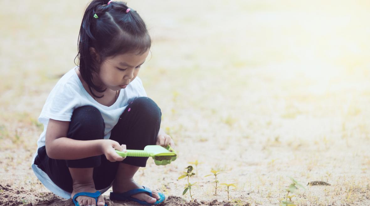 Young girl playing in sand