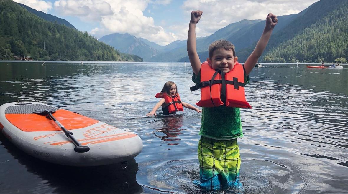 two kids paddleboarding